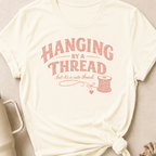 Hanging by a Thread But it's a Cute Thread T-Shirt